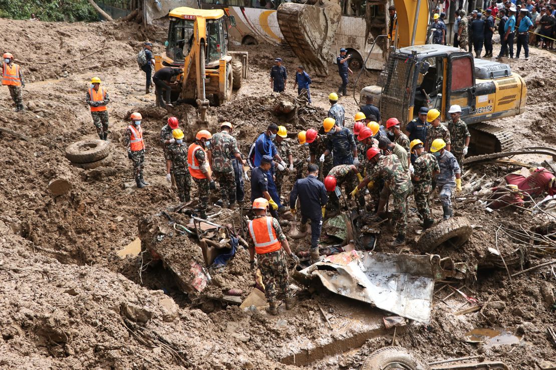 Rescue personnel at the site of a landslide after vehicles and  passengers were buried, at the Tribhuvan highway in Dhading, Nepal on September 29, 2024.