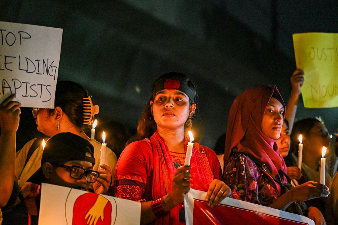 Bangladeshi women protesters hold candles during a protest against rape in Dhaka, Bangladesh, on August 17, 2024.