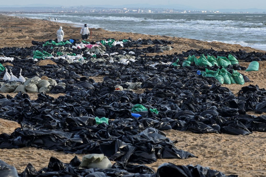 Volunteers work to clear spilled oil on the Russian coastline in the Kerch Strait, near the Black Sea resort of Anapa on December 21.