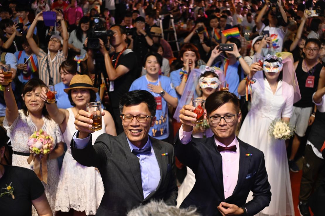 A gay couple makes a toast during a mass wedding banquet in front of the Presidential Palace in Taipei, Taiwan on May 25, 2019.