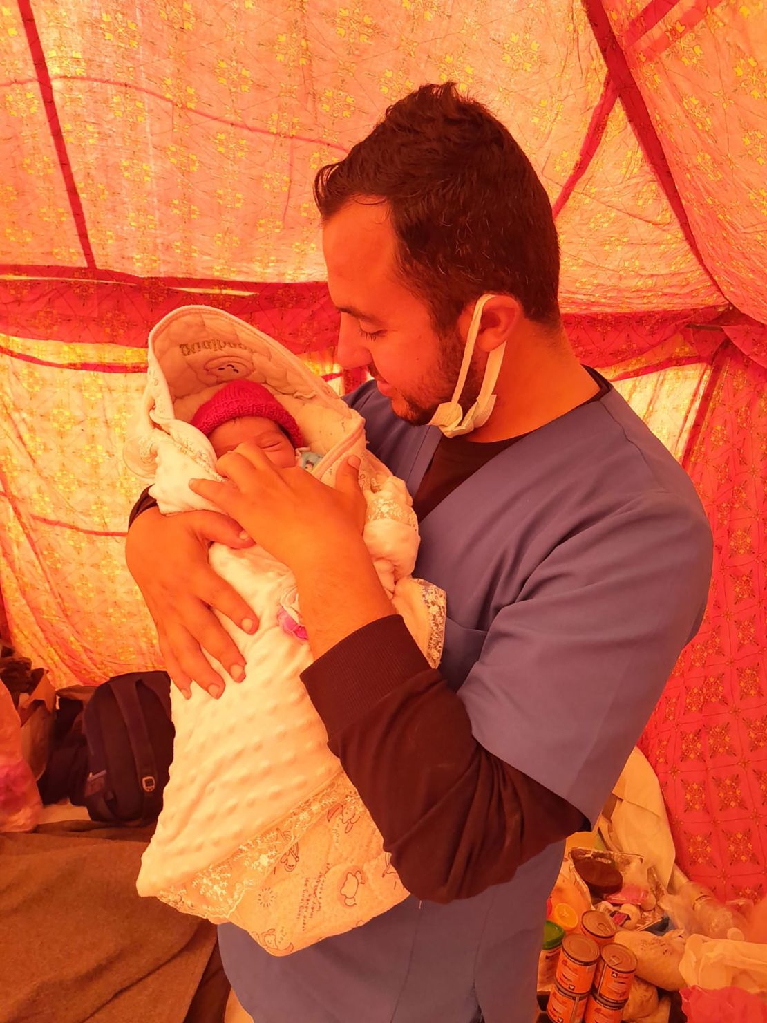 Raed Radwan, holds his newborn baby Maria, in Rafah, southern Gaza, on February 28. His wife, Mayas Sufyan Musa, told CNN the fear of Israeli attacks compounded the stress of her birth.