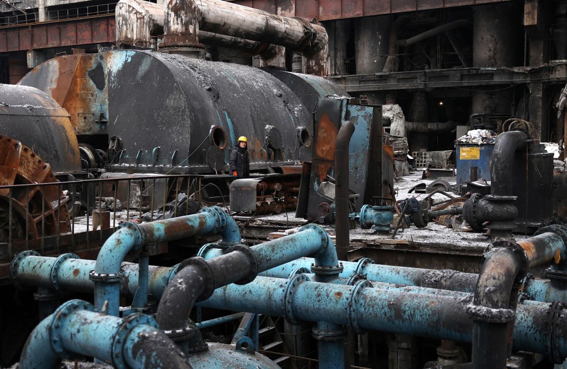 A worker stands as equipment is repaired at a thermal power plant damaged in a missile attack in an undisclosed location in Ukraine, on December 5, 2024.