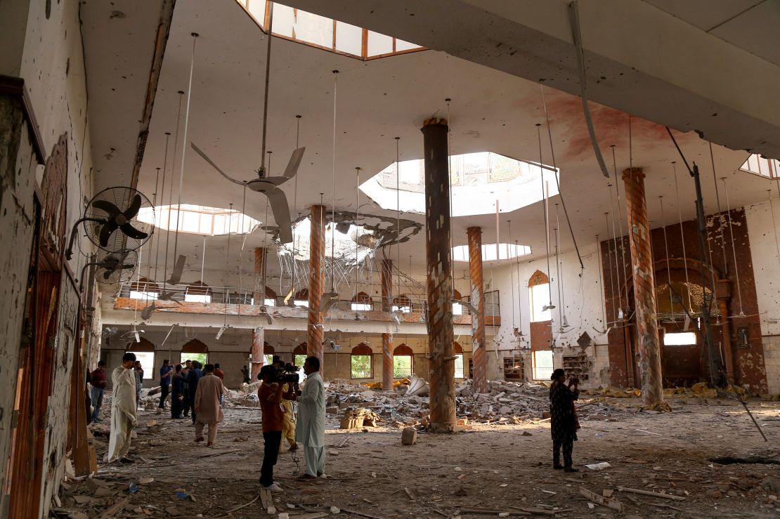 Members of the media film the inside of a building after it was hit by an Indian strike in Bahawalpur, Pakistan, on May 7.