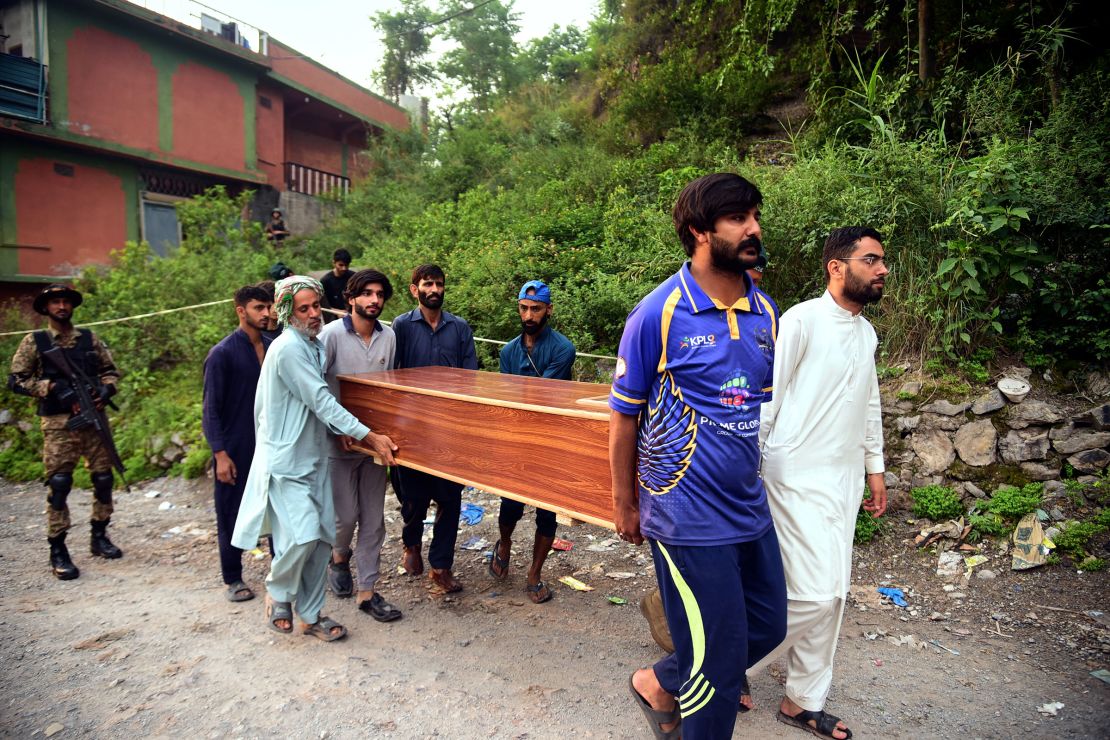 Volunteers carry a body after recovering it from the rubble of a mosque damaged by a suspected Indian missile attack near Muzaffarabad in Pakistan-administered Kashmir, on Wednesday, May 7, 2025.